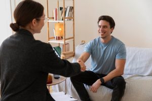 Therapist talking with a young man in a therapy session