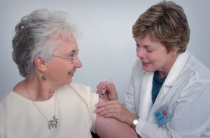 nurse inject an old woman