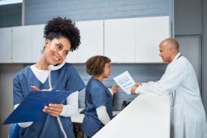 Medical Team Reviewing Documents and Assisting Patients in a Well-Organized Modern Clinic