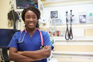 Smiling female nurse with arms folded at a medical facility